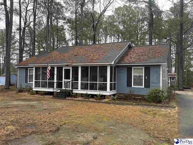 view of front facade with a sunroom