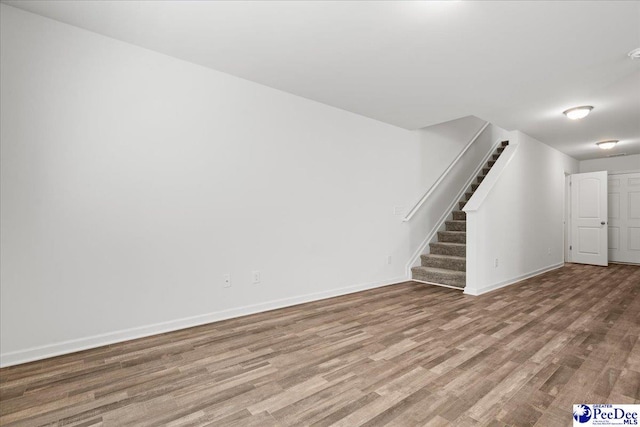 3229 Winding Way Dr, Florence, SC 29506 - unfurnished living room with stairway, wood finished floors, and baseboards