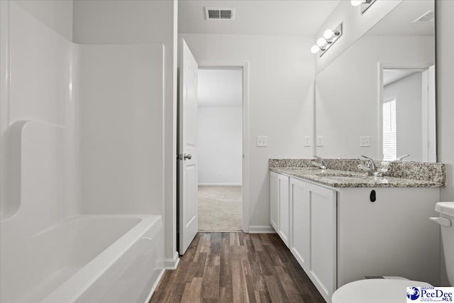 3229 Winding Way Dr, Florence, SC 29506 - full bath featuring toilet, wood finished floors, double vanity, baseboards, and  shower combination