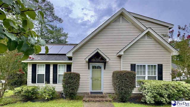 view of front facade with solar panels