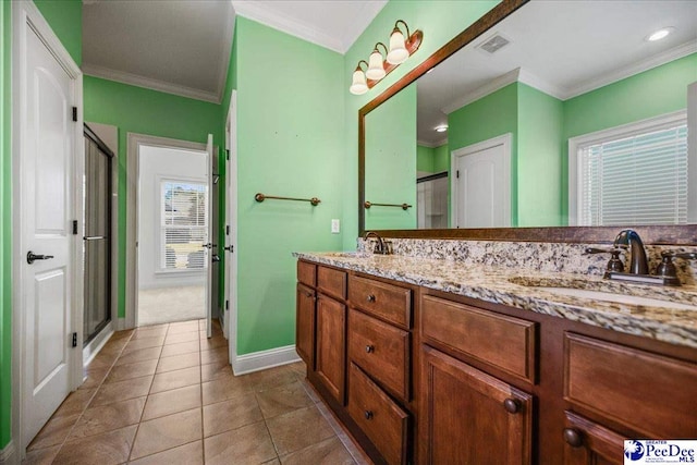 bathroom with crown molding, vanity, tile patterned floors, and a shower with shower door