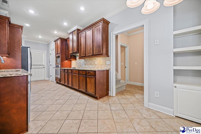 kitchen with built in features, decorative backsplash, light tile patterned floors, crown molding, and light stone countertops