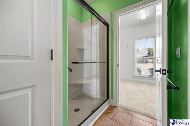 bathroom featuring tile patterned floors and a shower with door