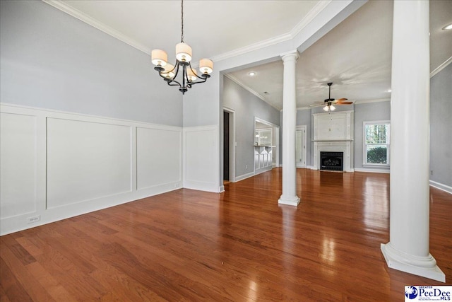 unfurnished living room featuring ceiling fan with notable chandelier, ornamental molding, wood-type flooring, and decorative columns