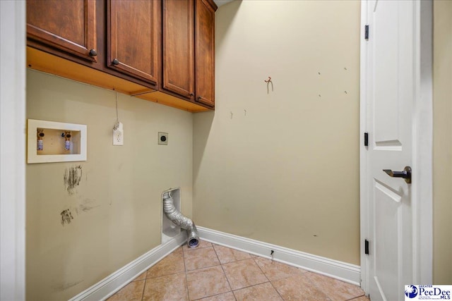 clothes washing area with light tile patterned flooring, cabinets, washer hookup, and hookup for an electric dryer