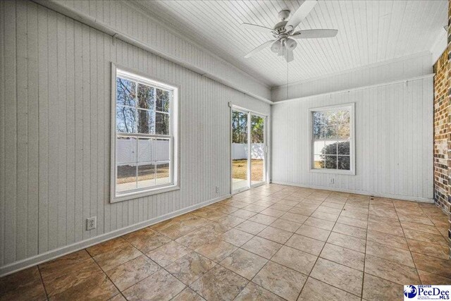 unfurnished sunroom with ceiling fan