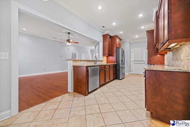 kitchen featuring light tile patterned floors, ornamental molding, ceiling fan, and appliances with stainless steel finishes