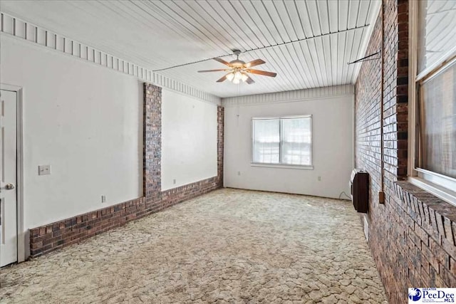 spare room with carpet flooring and a ceiling fan