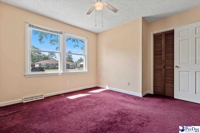 unfurnished bedroom with baseboards, a closet, visible vents, and carpet