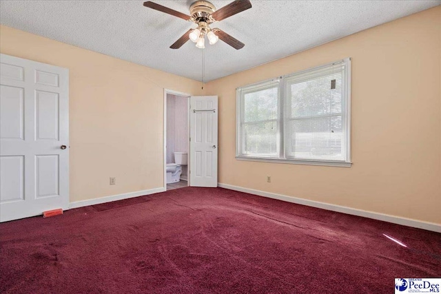 unfurnished bedroom with baseboards, carpet, and a textured ceiling