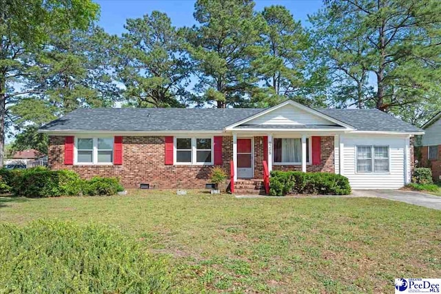 view of front facade with a front yard, a porch, brick siding, and crawl space