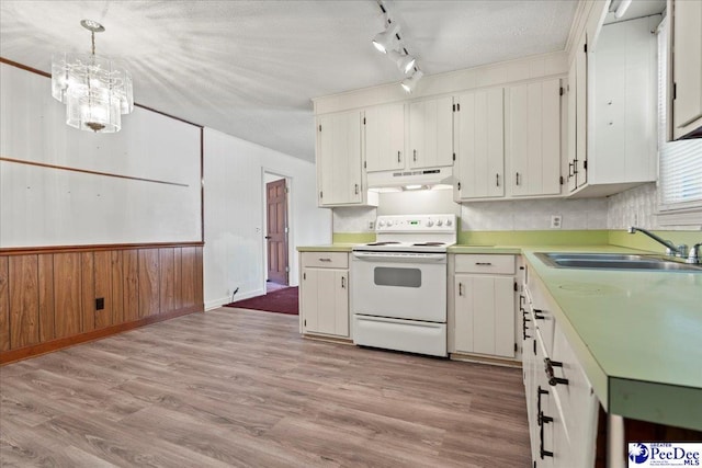 kitchen with under cabinet range hood, a sink, track lighting, white electric range oven, and light countertops