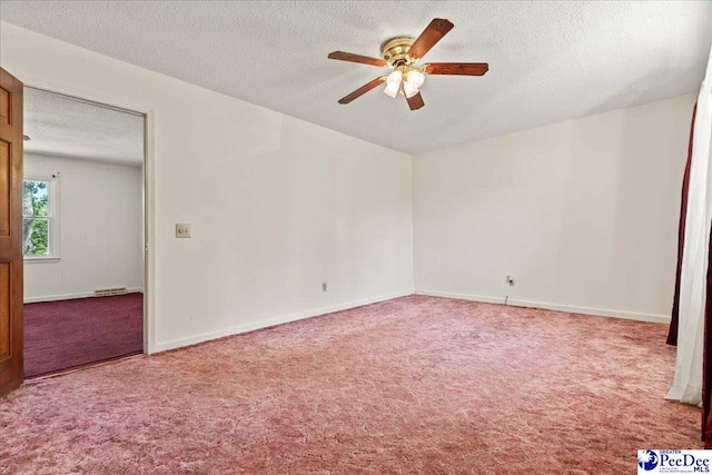 spare room with carpet flooring, a ceiling fan, a textured ceiling, visible vents, and baseboards