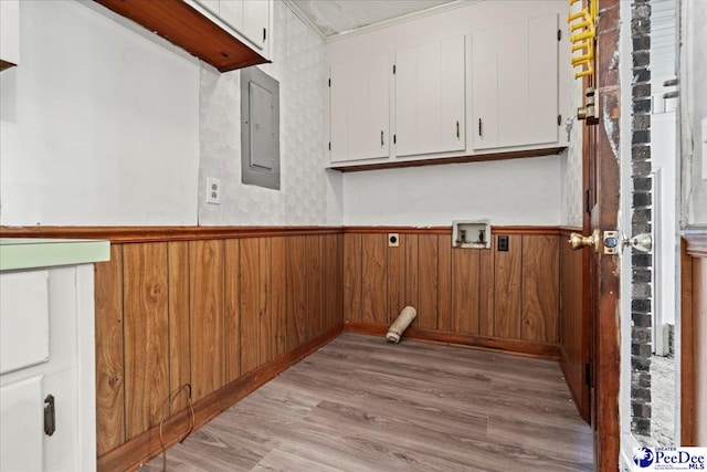 laundry area with cabinet space, washer hookup, light wood finished floors, and wainscoting