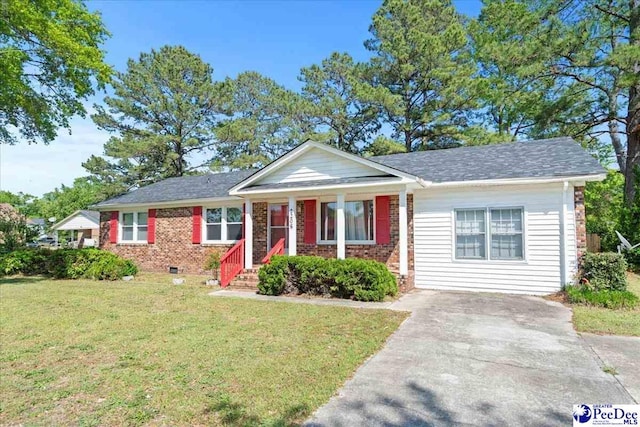 view of front facade with covered porch, brick siding, driveway, and a front yard