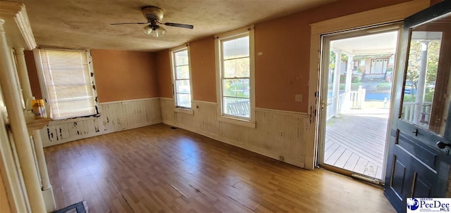 doorway featuring hardwood / wood-style flooring and ceiling fan