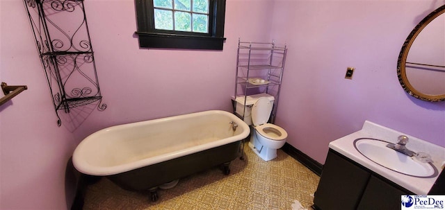 bathroom with vanity, a bath, and toilet