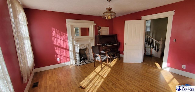 interior space featuring wood-type flooring and a chandelier