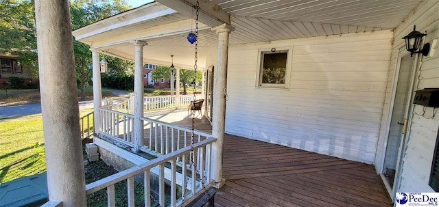 wooden terrace featuring a porch