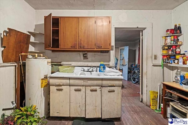 kitchen with water heater and dark hardwood / wood-style flooring