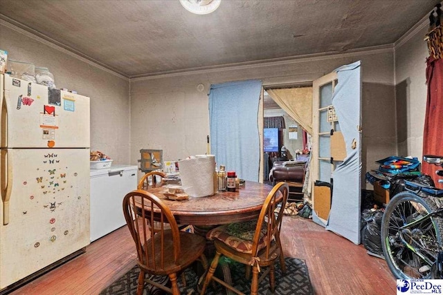 dining space with ornamental molding and wood-type flooring