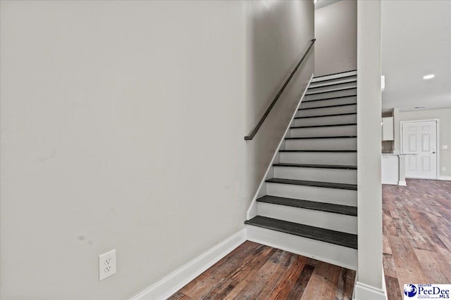 stairs featuring baseboards and wood finished floors