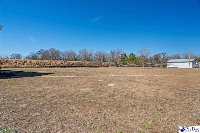 view of yard with a rural view