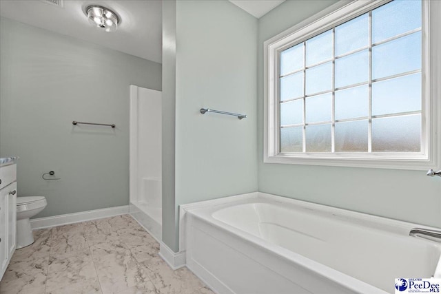 bathroom featuring marble finish floor, plenty of natural light, baseboards, and a bath