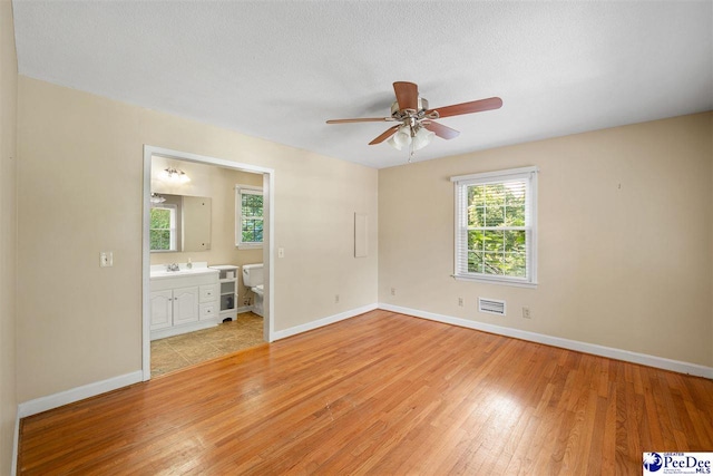 3116 Kenfield Ln, Florence, SC 29505 - unfurnished bedroom with light wood finished floors, baseboards, and a sink