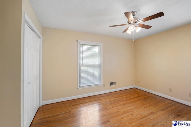 3116 Kenfield Ln, Florence, SC 29505 - unfurnished bedroom with light wood-style flooring, baseboards, a closet, and ceiling fan