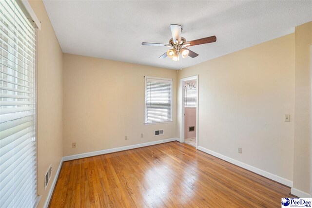 3116 Kenfield Ln, Florence, SC 29505 - empty room with a ceiling fan, baseboards, and light wood-type flooring