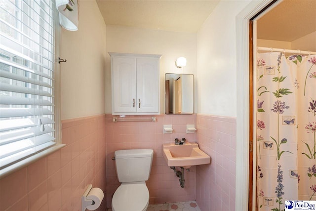 3116 Kenfield Ln, Florence, SC 29505 - full bathroom with wainscoting, tile walls, toilet, a sink, and a shower with curtain