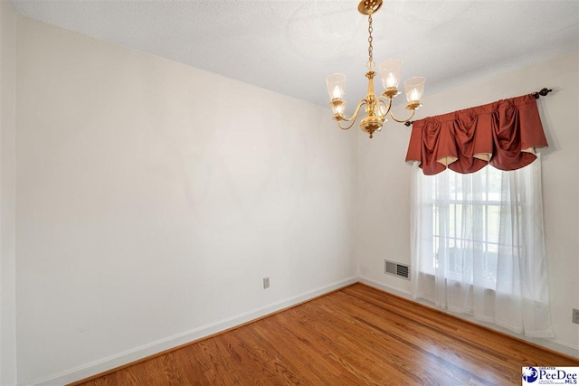3116 Kenfield Ln, Florence, SC 29505 - spare room with a chandelier, wood finished floors, and baseboards