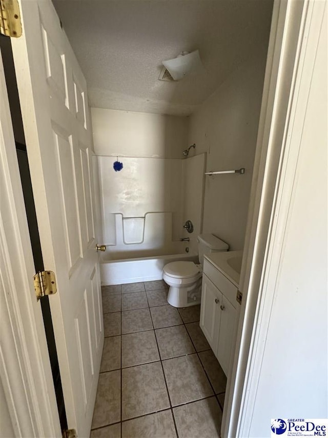 full bathroom with toilet,  shower combination, a textured ceiling, vanity, and tile patterned flooring