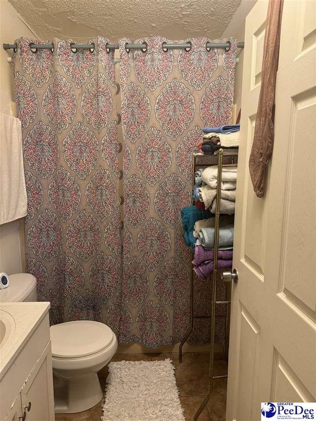 bathroom featuring vanity, a textured ceiling, toilet, and a shower with shower curtain