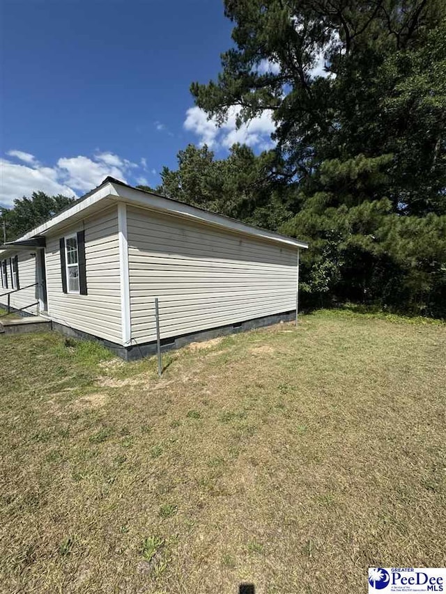 view of side of home featuring a yard