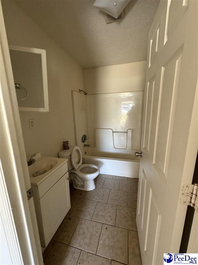 full bathroom featuring vanity, a textured ceiling, tile patterned floors, shower / bathtub combination, and toilet