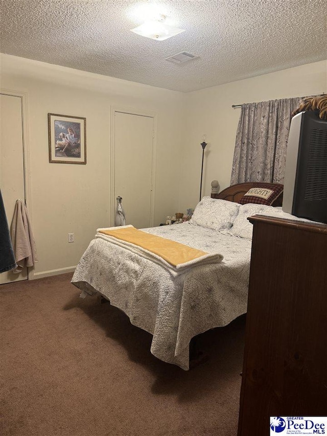 carpeted bedroom featuring a textured ceiling