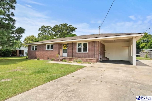 2217 W Mccown Dr, Florence, SC 29501 - single story home with brick siding, a front lawn, an attached carport, and driveway