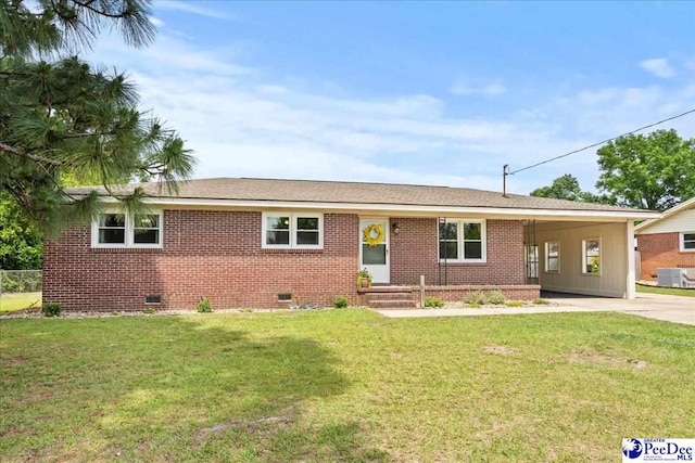 2217 W Mccown Dr, Florence, SC 29501 - ranch-style house featuring crawl space, driveway, an attached carport, central AC unit, and a front lawn