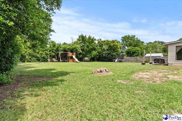 2217 W Mccown Dr, Florence, SC 29501 - view of yard featuring a trampoline and a playground
