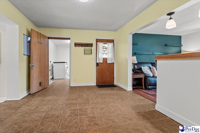2217 W Mccown Dr, Florence, SC 29501 - hallway with washer / dryer, baseboards, and tile patterned flooring