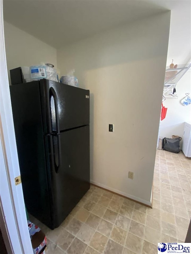 kitchen featuring black refrigerator