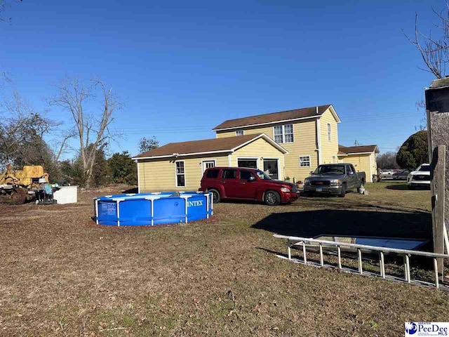 back of house with a yard