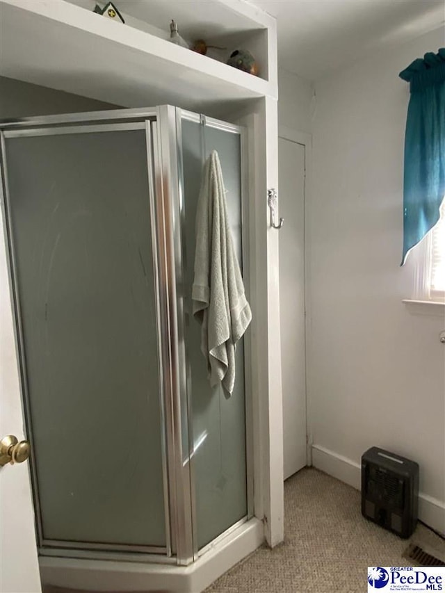 bathroom featuring an enclosed shower