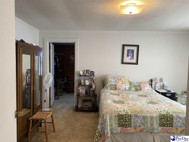 bedroom featuring crown molding, a textured ceiling, and carpet flooring