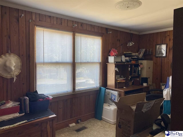 office area featuring ornamental molding, light carpet, and wood walls