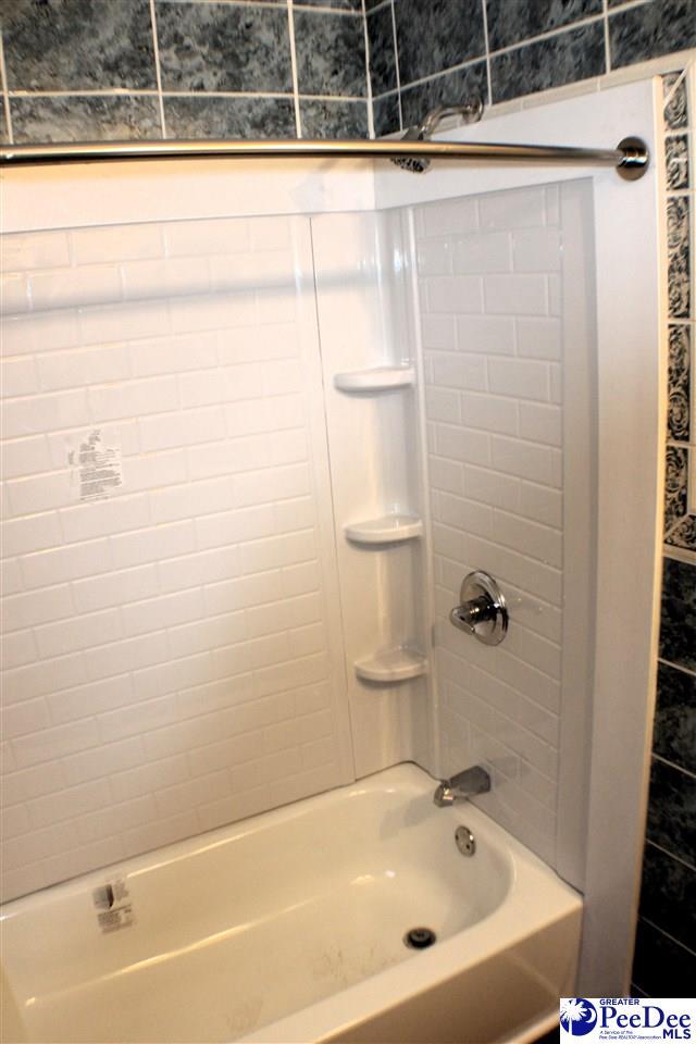 full bath featuring shower / bathtub combination