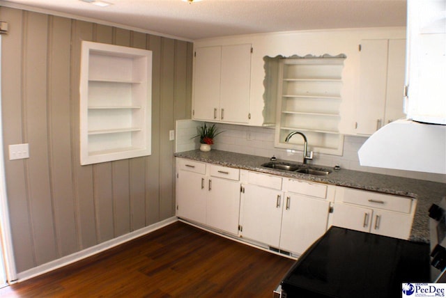 kitchen with dark wood-style flooring, open shelves, a sink, baseboards, and white cabinets