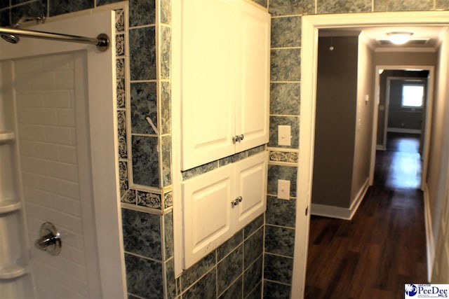 full bathroom featuring walk in shower and wood finished floors
